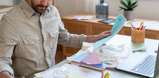 Why Neglecting Bookkeeping Automation is Risky - bookkeeper surrounded by receipts and paperwork